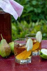 Fermented Raw Kombucha Tea with Pears, Summer Healthy Detox Drink in jar and two glass, vertical orientation