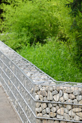 Decorative stones stored in the frame for a low wall.