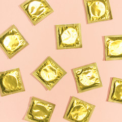 Top view condoms with golden wrappers