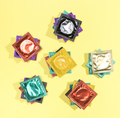 Top view colourful condoms in wrappers