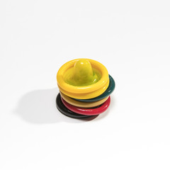 High angles colourful condoms on white background