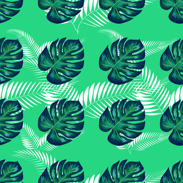Green pattern with monstera palm leaves. Seamless summer tropical fabric design.