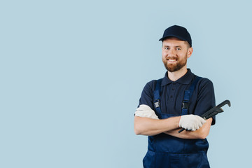 Portrait of a happy service worker with hands crossed, dressed in uniform - obrazy, fototapety, plakaty