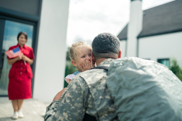 Daughter crying because of happiness while seeing daddy back home