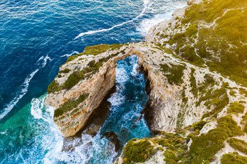 Tripitos Arch, natural arch in the sea at Paxos Island, aerial view. Greece.
