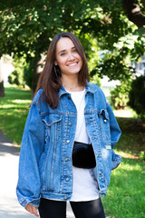 Portrait of beautiful young girl posing in summer park. Majestic woman's beauty. Youth, happiness, lifestyle.