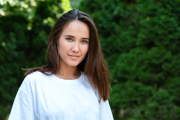 Portrait of beautiful young girl posing in summer park. Majestic woman's beauty. Youth, happiness, lifestyle.