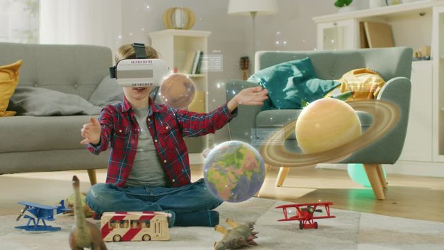 Smart Little Boy Wearing Augmented Reality Headset Plays with Space Learning Software, With Gestures He Manipulates 3D Planets, Discovers Facts About Solar System and Cosmos