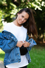 Portrait of beautiful young girl posing in summer park. Majestic woman's beauty. Youth, happiness, lifestyle.