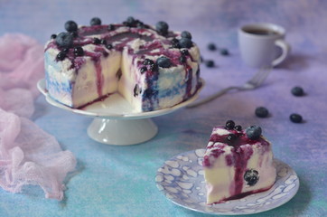 A piece of cold cheesecake with blueberries on a plate