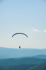 Paraglider flight over the mountains.