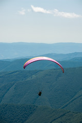Paraglider flight over the mountains.