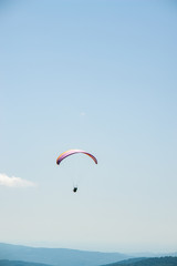 Fototapeta na wymiar Paraglider flight over the mountains.
