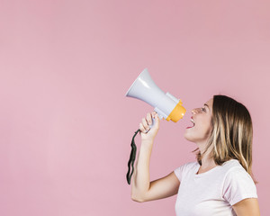 Side view girl speaking on a megaphone