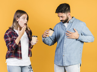 Medium shot couple with coffee cups
