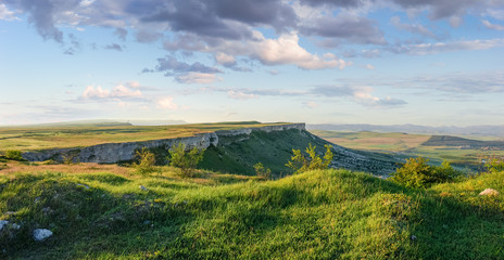 Fototapeta na wymiar Panorama of the plateau with precipitous edges against sky