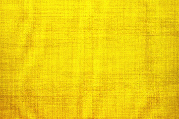 Textured background of yellow natural textile   