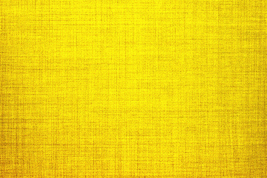 Textured background of yellow natural textile   