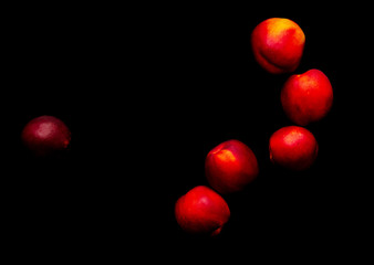 Ripe nectarine on a black background