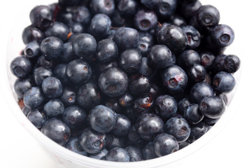 Blueberries in a glass on a white background