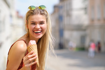 Cheerful girl eating ice cream cone