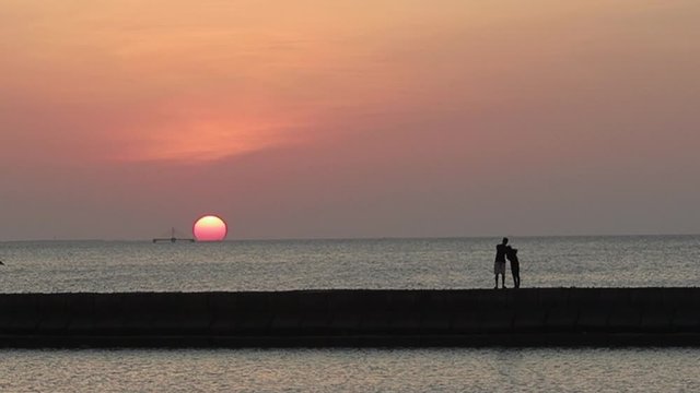 Silhouette of people looking at the sunset by the sea, East Nusa Tenggara kupang