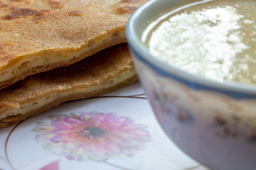 Egg Paratha with Dalia or Daliya, Cereal Food Know as Bulgur Cooked in Milk Served with Egg Stuffed Paratha or Indian Stuffed Bread with Egg or Fried Flatbread, Selective focus.