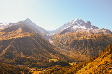 Fototapeta premium Beautiful sunset over the mountains in French Alps near Chamonix. Snow capped mountains in background. Mountains sunset. Late summer, autumn. Mountain silhouettes. Amazing nature