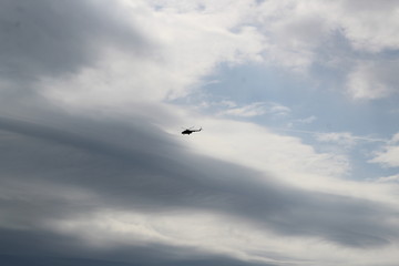 silhouette of big military helicopter in the sky