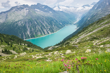 View of a turquoise colored lake and glacier in the Alps, Europe
