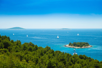Fototapeta na wymiar Panoramic view on Kosirina lagoon on Murter island in Croatia, sailing boats and yachts on blue seascape
