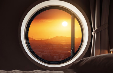 Looking through window, city view sunset with the sun in Japan