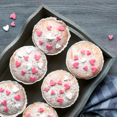 Sugar-sprinkled muffins with pink and white fondant icing hearts
