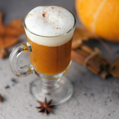 Autumn coffee pumpkin latte in a glass with cinnamon
