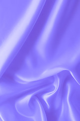 Smooth elegant wavy blue satin silk luxury cloth fabric texture, abstract background design.