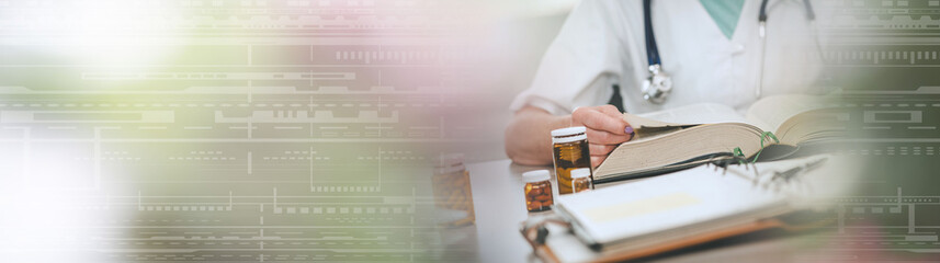 Female doctor reading a textbook; panoramic banner