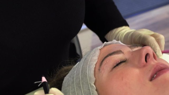Young girl make permanent makeup. Eyebrow Microblading