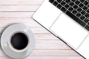 Beige wooden desk table with coffee and Macbook. Apple Inc. is an American multinational technology company. Moscow, Russia - April 26, 2019