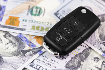car key on dollars banknotes closeup