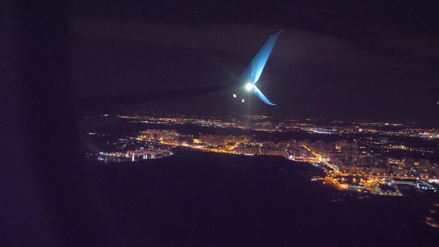 night city view from above. takeoff airplane aircraft flight concept. the plane taking off at night at the airport strip. plane landing. the view from the window of the plane you can see the wing and