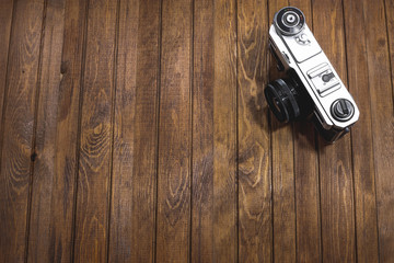 Retro camera on wooden boards background