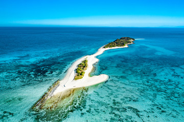 Truly amazing tropical island in the middle of the ocean. Aerial view of an island with white sand beaches and beautiful lagoons