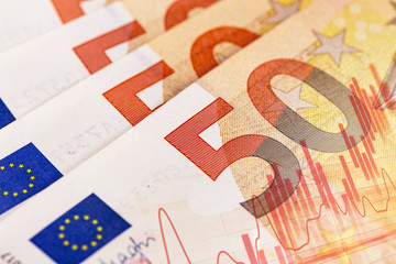 closeup fifty euro bankontes with digital chart background
