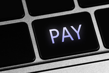 closeup keyboard and button with text Pay