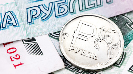 closeup macro one russian ruble metal coin and 1000 thousand rubles banknotes