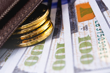 closeup stack golden metal coins and dollars in wallet