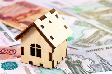 finance concept in wooden house symbol and Russian money, rubles banknotes