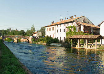 the waterway runs slowly up to Milan between old farmhouses and beautiful villas