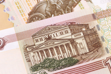 macro closeup stack of Russian bankonte 100 rubles. General view of the building of the Bolshoi Theater (Moscow)