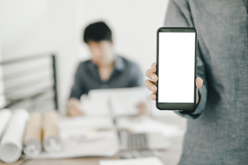Mockup image of engineers showing smartphone design building Project in office, mockup concept